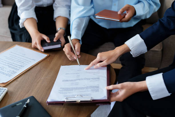 istock Couples sign important documents with insurance agents 1423882481