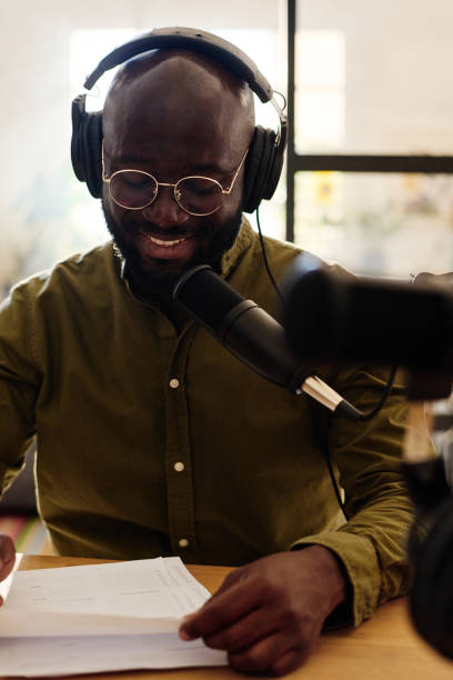istock Young smiling African American man looking through questions on paper 1423887842