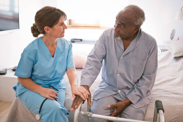 istock Female caregiver with senior man 1423889416