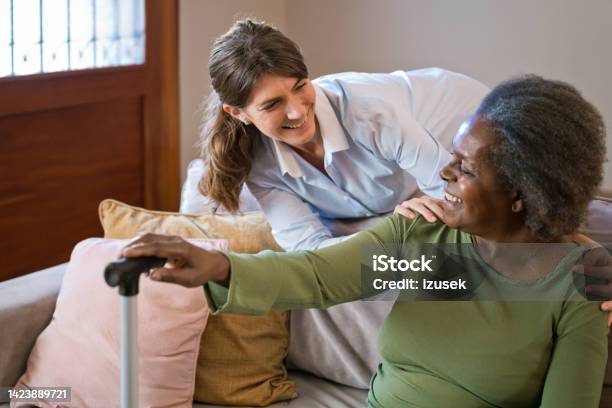 Female Nurse With Senior Woman At Home Stock Photo - Download Image Now - 70-79 Years, Adult, Adults Only