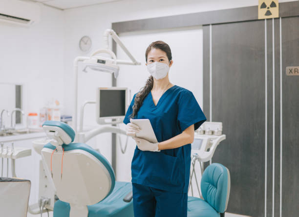 istock Chinese female dentist looking at camera smiling in her office 1423894586