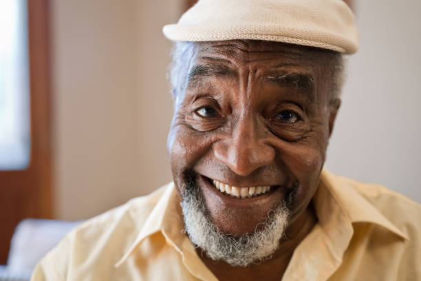 istock Smiling senior man with cap at home 1423894591