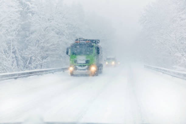 istock Truck on ice cold road during blizzard 1423900369