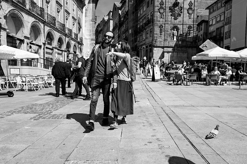Porto , Portugal; 15 April 2022: Heterosexual tourist couple in downtown Porto enjoying the city