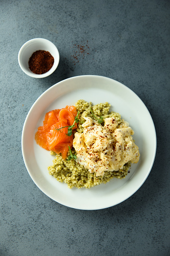 Scrambled eggs with couscous and smoked salmon