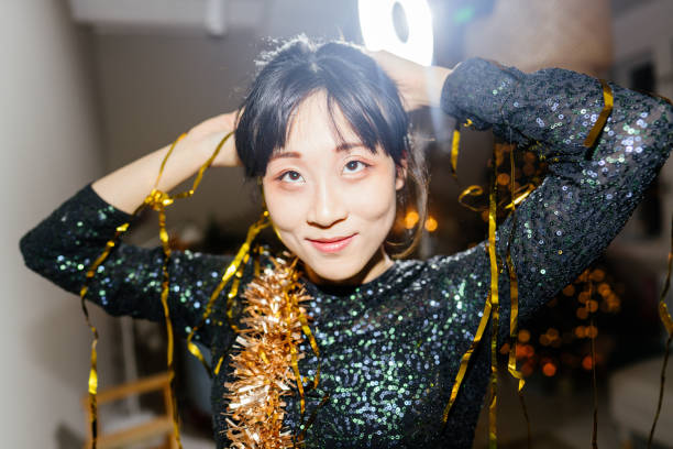 Photo of a young woman at New Year's party celebration in her home