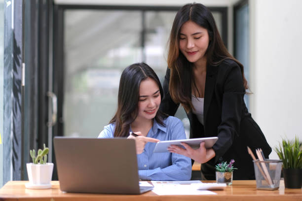 istock Two Young Asian businesswoman discuss with new startup project Idea presentation, analyze planning and financial statistics and investment market at office. 1423907649