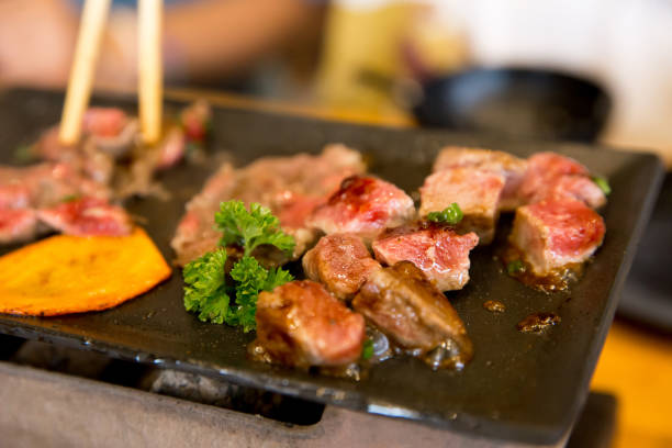 istock Top view of dice beef on the hot pan with chopsticks 1423918253