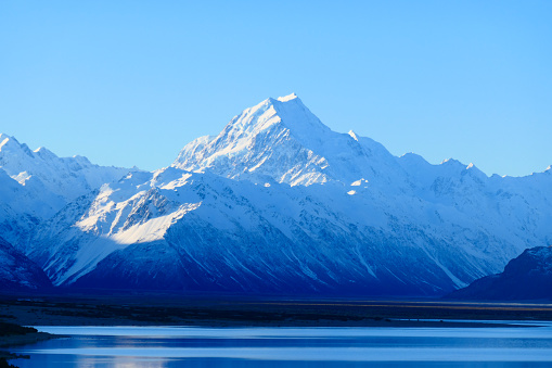 Aoraki Mount Cook and Lake Pukaki in the Southern Alps of New Zealand on a sunny afternoon in early Spring.