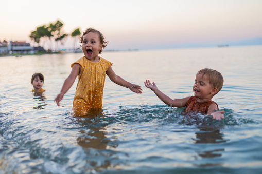 Children are dressed in the sea and play with salt water.