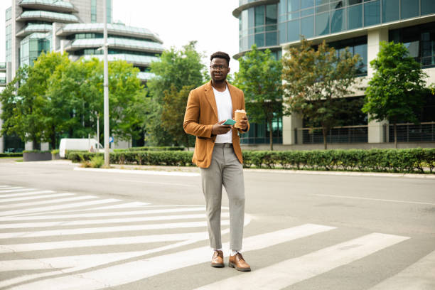 istock Portrait of a young African man on a coffee break using smartphone 1423926005