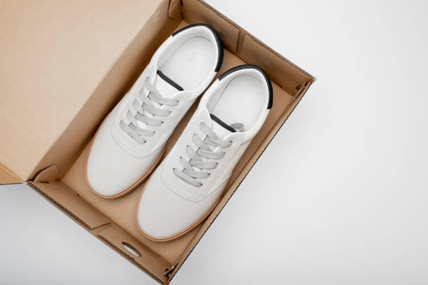 istock One white casual sneakers in a brown cardboard box 1423926452