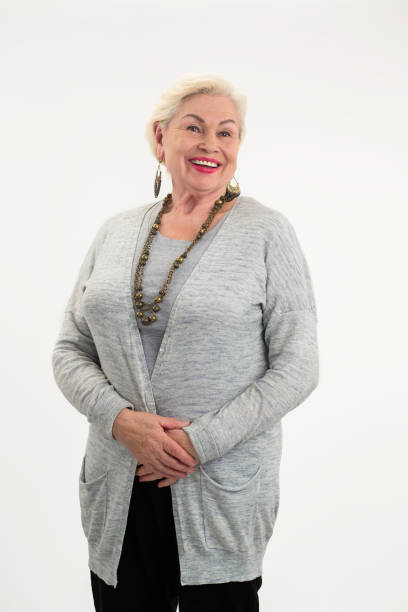 istock Senior woman standing and smiling. 1423926782