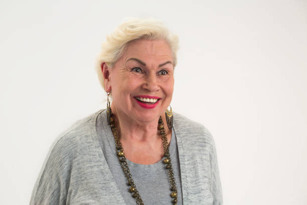 Isolated elderly woman smiling. Lady with happy face expression.