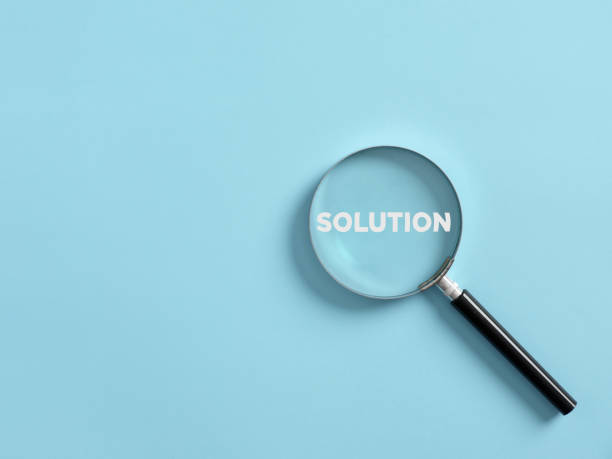 istock Magnifier focuses on the word solution. Searching for a business solution concept. 1423931585