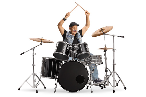 Cheerful mature drummer with drumsticks up isolated on white background