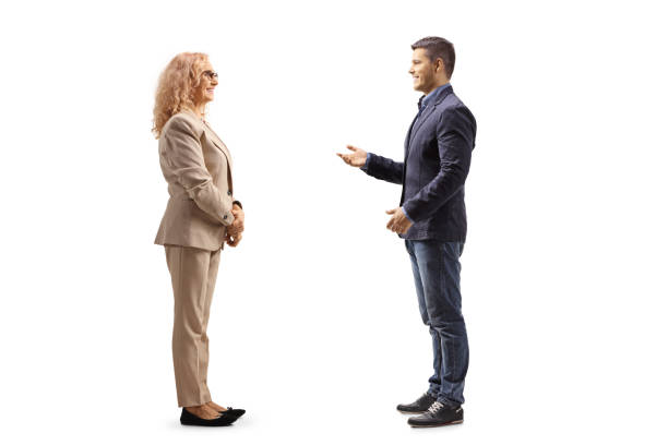 Conversation between a young man and an older woman in business casual clothes Conversation between a young man and an older woman in business casual clothes isolated on white background man standing profile stock pictures, royalty-free photos & images