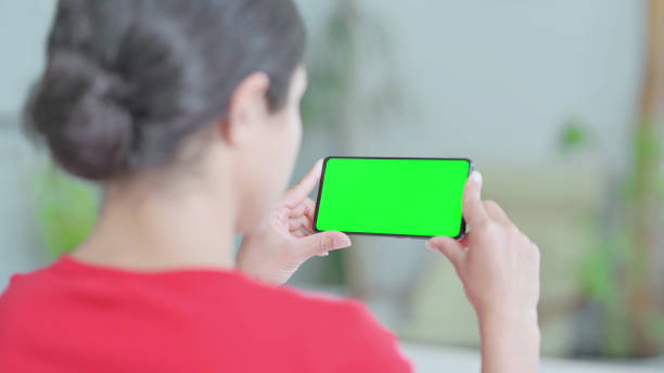 istock Indian Woman Watching Smartphone with Chroma Screen 1423933347
