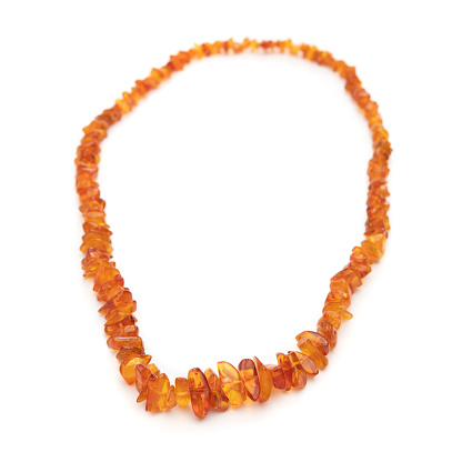 Raw Baltic amber beads necklace isolated on white background