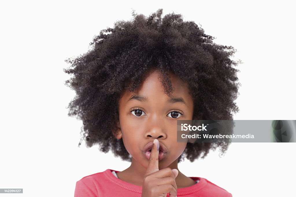 Close up of a girl asking silence Close up of a girl asking silence against a white background Girls Stock Photo