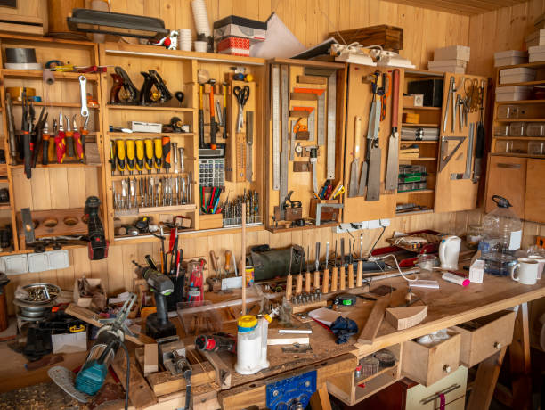 istock Above the carpenter's table, on the wall, there are shelves with various carpentry tools. 1423942218