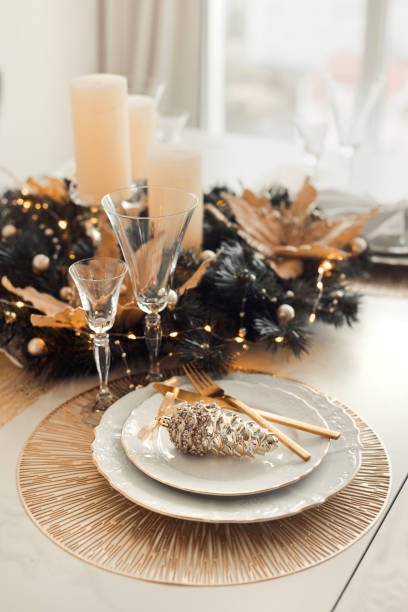 istock Christmas table luxury decoration in golden colors. Festive table setting for dinner on winter holidays 1423942293