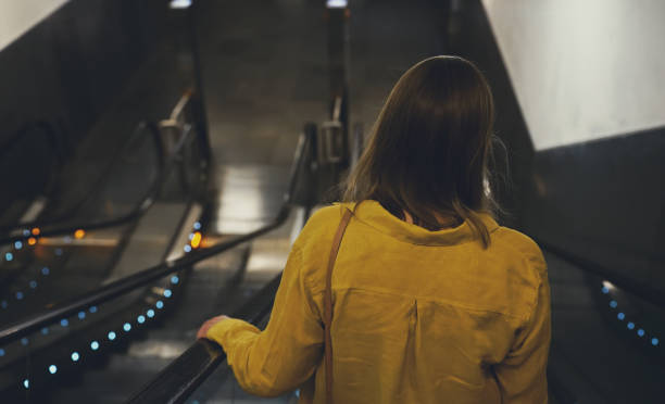 istock Woman using an escalator in metro. 1423946273
