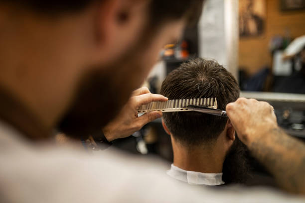 istock Customer in barber shop having haircut 1423950529