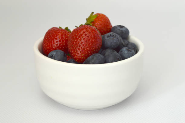 A variety of strawberries and blueberries in pint baskets