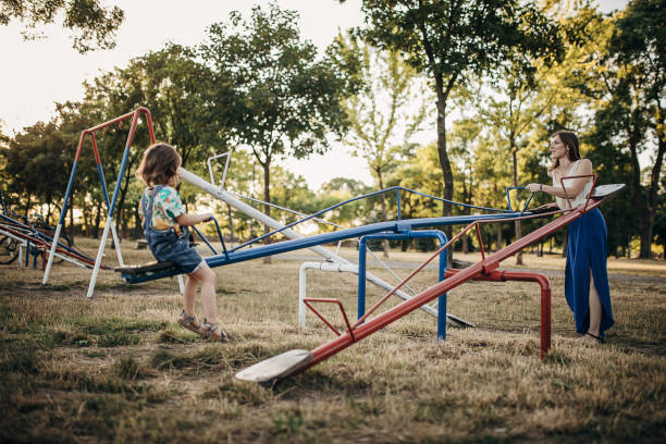 istock Mother and daughter having fun together on playground 1423950734