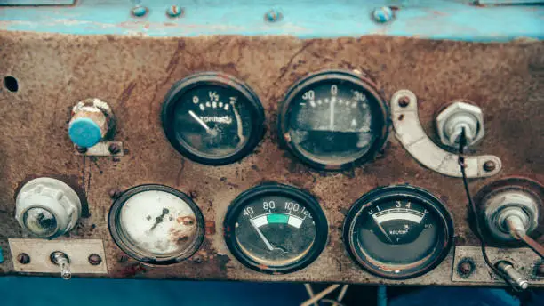 Photo of The rusty steel dashboard of a very old tractor close-up