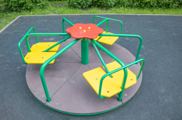Multi-colored steel round carousel on the playground stock photo