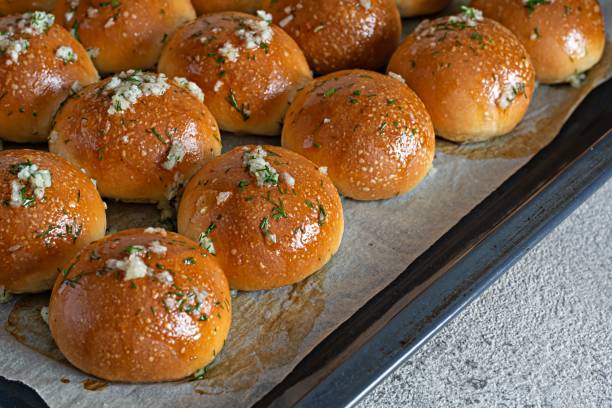 istock Freshly baked buns (pampushki) with garlic and dill for the first course (soup) on a baking tray. National Ukrainian dish, food. Selective focus. 1423958468