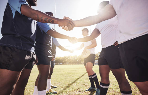 istock Two opponent rugby teams shaking hands before or after a match outside on a field. Rugby players sharing a handshake to show respect and sportsmanship. A mutual understanding for the game to be played 1423959320