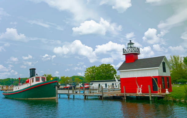 istock Lighthouse-Tug boat with lighthouse in background-Douglas  Michi 1423959420
