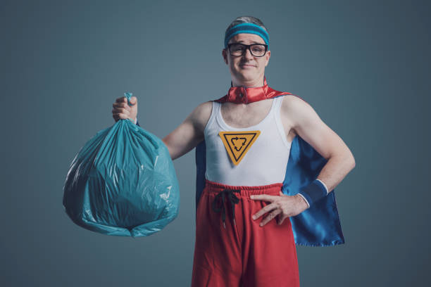 istock Ecology superhero holding a trash bag 1423960681