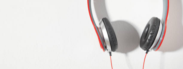 istock Red headphones on the wall. Music. Technology 1423960885