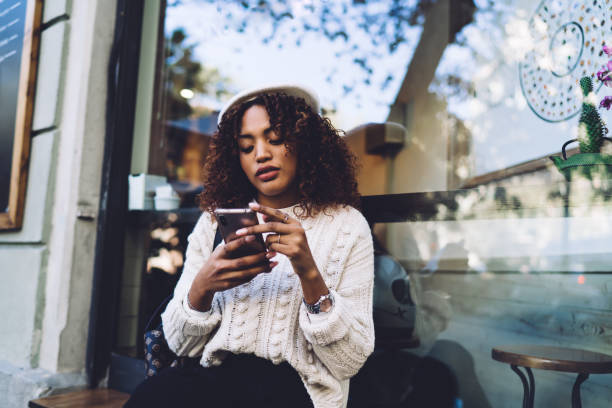 istock Thoughtful African American woman using smartphone on street 1423961015
