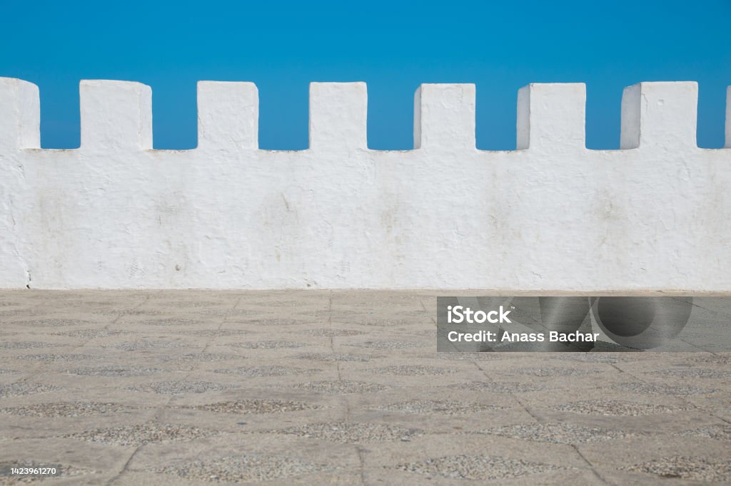 Asilah Morocco view of white rampart against blue sky - Asilah, Morocco Abstract Stock Photo