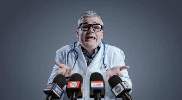 istock Funny medical scientist interviewed by the media 1423964304