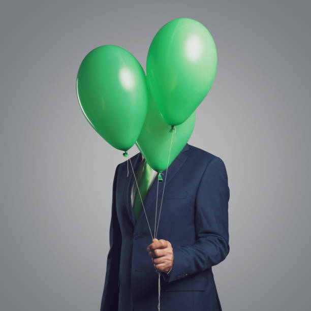 istock Businessman hiding behind balloons 1423965577