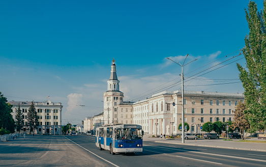 Cheboksary, Russia. 2022, July 25. Republic Square in the center of the city. The building of the Chuvash State Agrarian University. The old blue trolleybus.