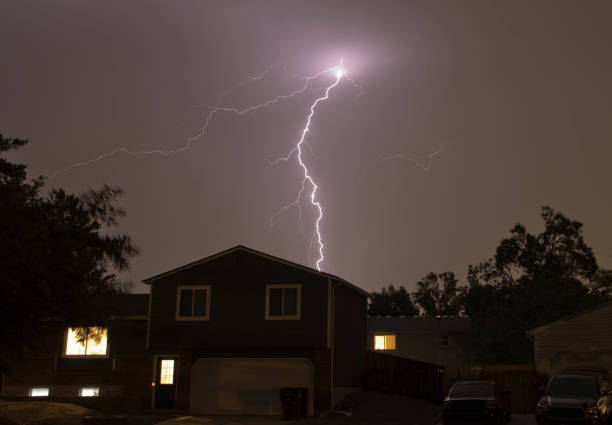 Lightning bolts strike over Denver Colorado neighborhood homes stock photo