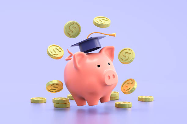 Piggy bank with coins and graduation cap on blue background stock photo