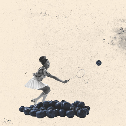 Contemporary art collage. Creative design with young woman playing badminton with blueberries. Concept of retro style, food, sport, creativity, surrealism, imagination. Copy space or ad, poster