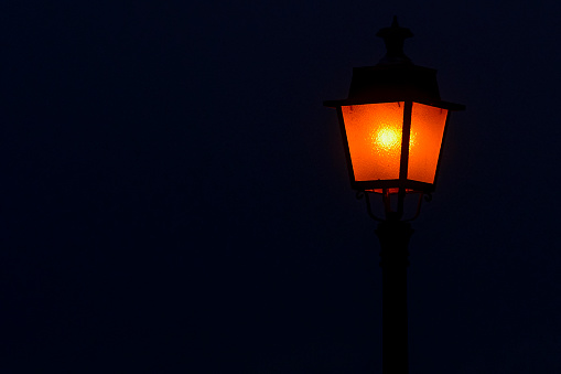 street lamps under blue sky at dusk