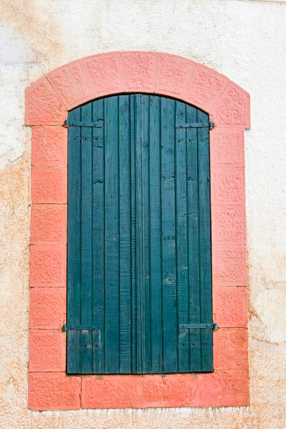 istock Wooden door with stone frame painted pink. 1423971122