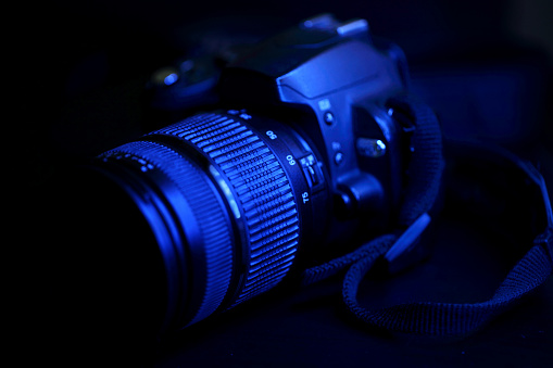 Digital camera illuminated with blue light.