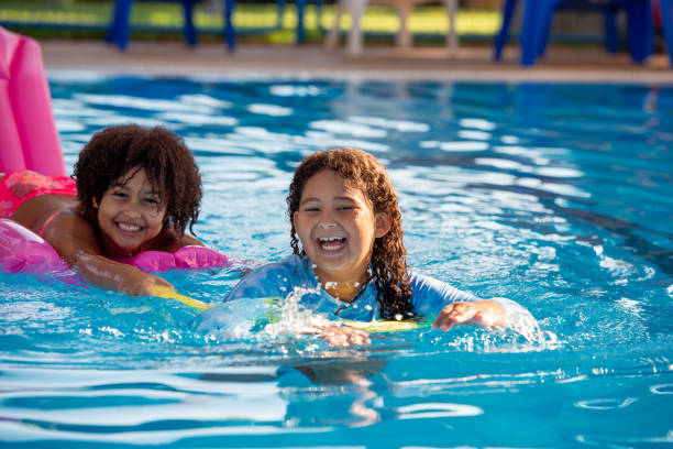 istock Multiracial elementary-age girls having fun in the swimming pool. 1423972334