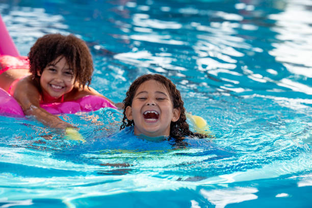 istock Multiracial elementary-age girls having fun in the swimming pool. 1423972819